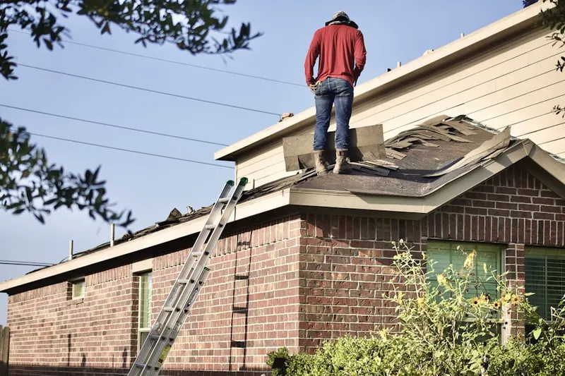 Professional roofer working on a residential roof in Greenline